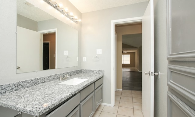 bathroom featuring vanity, a textured ceiling, and tile patterned floors