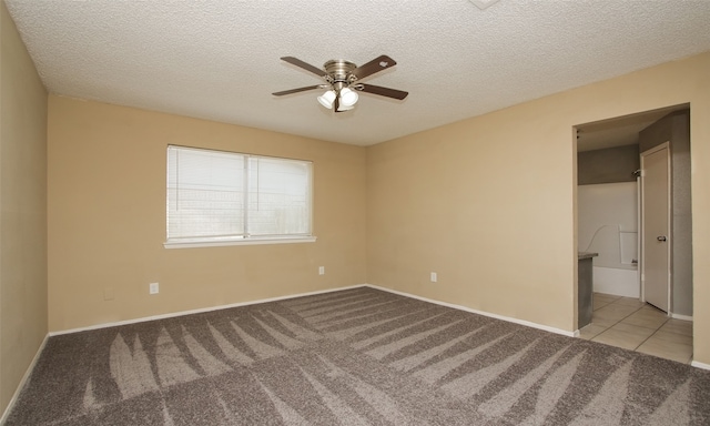 carpeted empty room with a textured ceiling and ceiling fan