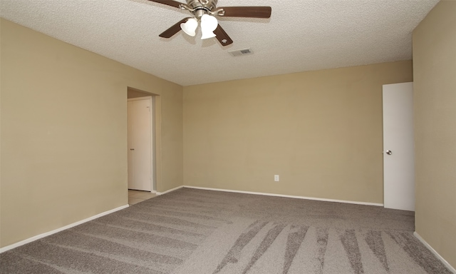 carpeted spare room with ceiling fan and a textured ceiling