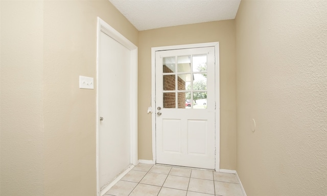 entryway featuring a textured ceiling and light tile patterned flooring