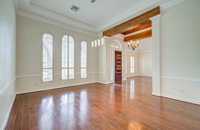 spare room with beamed ceiling, dark wood-type flooring, crown molding, and a chandelier