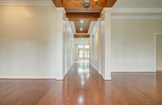 hall with crown molding, hardwood / wood-style floors, beam ceiling, and ornate columns