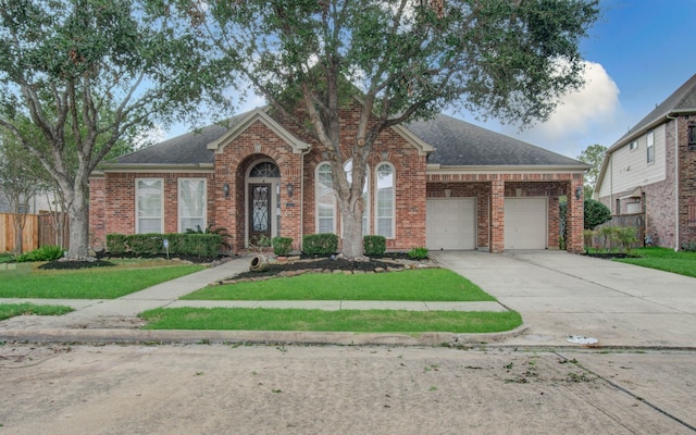 view of front facade featuring a front yard and a garage