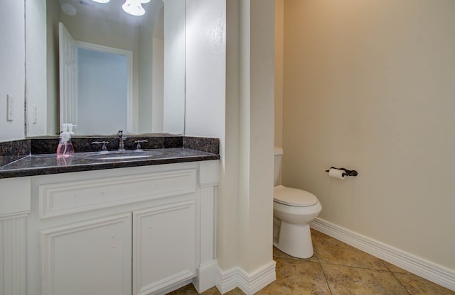 bathroom featuring toilet, vanity, and tile patterned floors