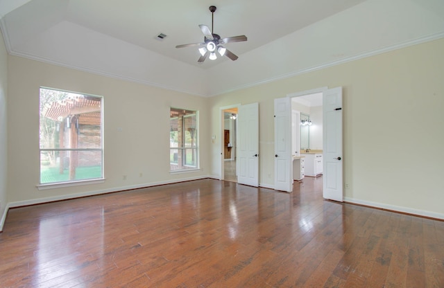 unfurnished room featuring crown molding, a raised ceiling, ceiling fan, and dark hardwood / wood-style flooring