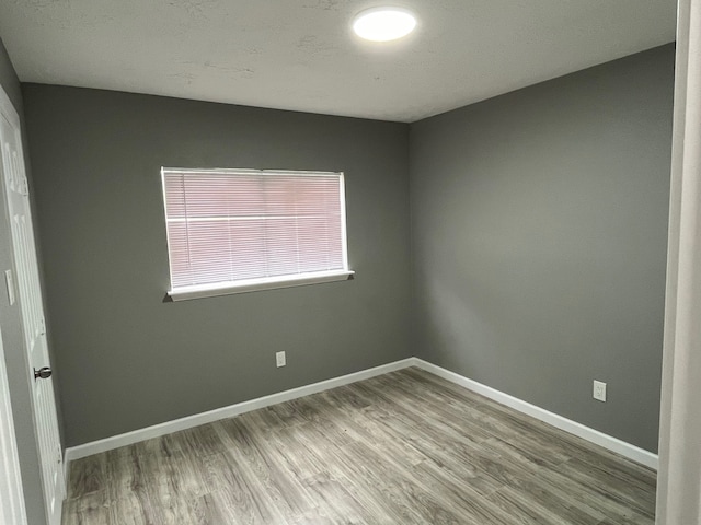 spare room with hardwood / wood-style floors