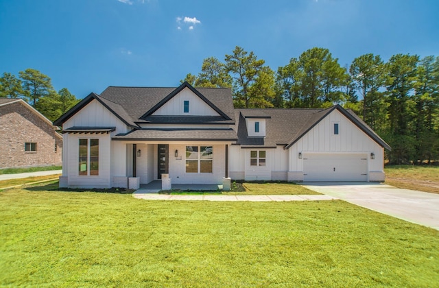 modern farmhouse style home featuring a front yard and a garage