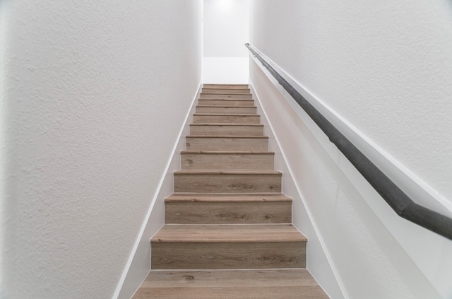 stairs with hardwood / wood-style floors