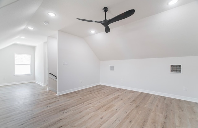 additional living space featuring light hardwood / wood-style flooring, vaulted ceiling, and ceiling fan