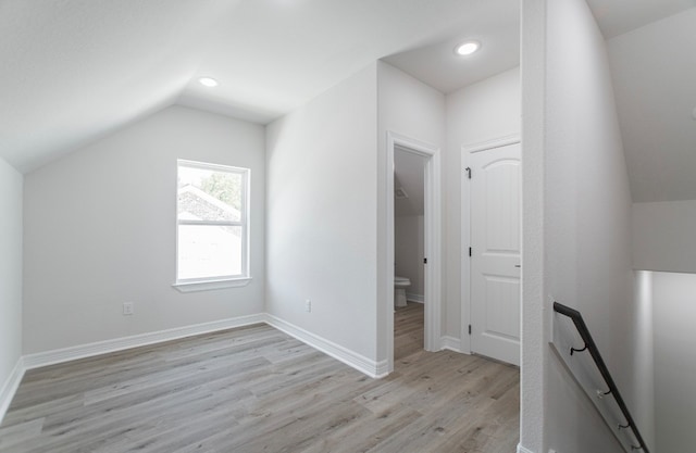 bonus room with light hardwood / wood-style floors and lofted ceiling