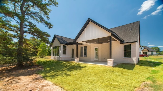 back of property featuring a patio and a yard