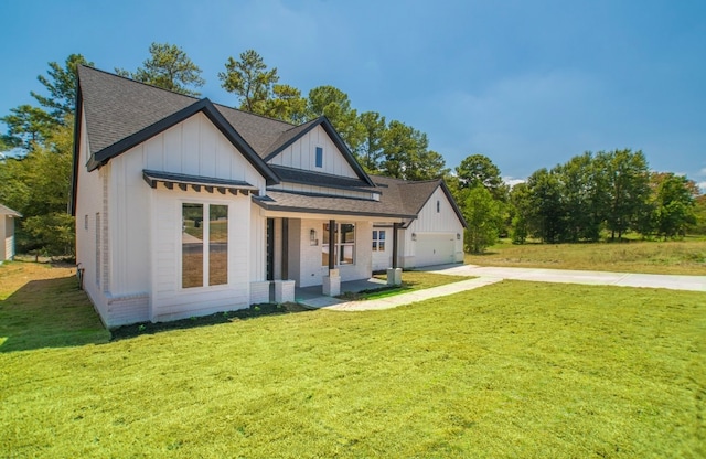 view of front of home featuring a porch, a garage, and a front yard