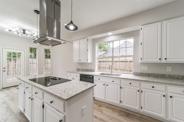 kitchen with black appliances, light stone counters, a kitchen island, island exhaust hood, and white cabinets