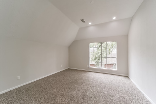 bonus room featuring carpet and vaulted ceiling