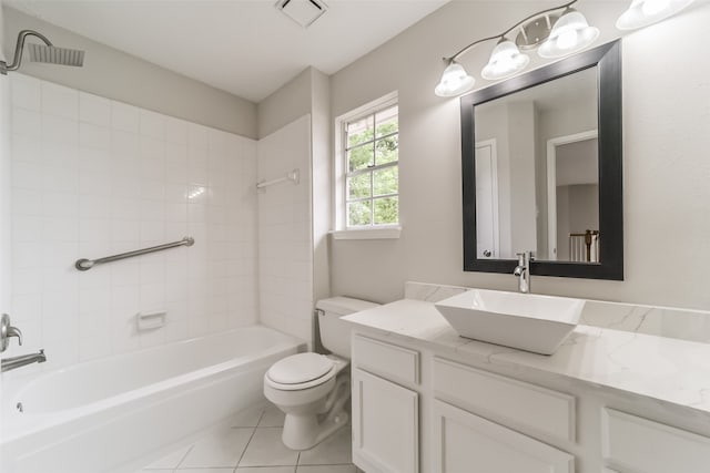 full bathroom featuring tile patterned floors, tiled shower / bath, toilet, and vanity