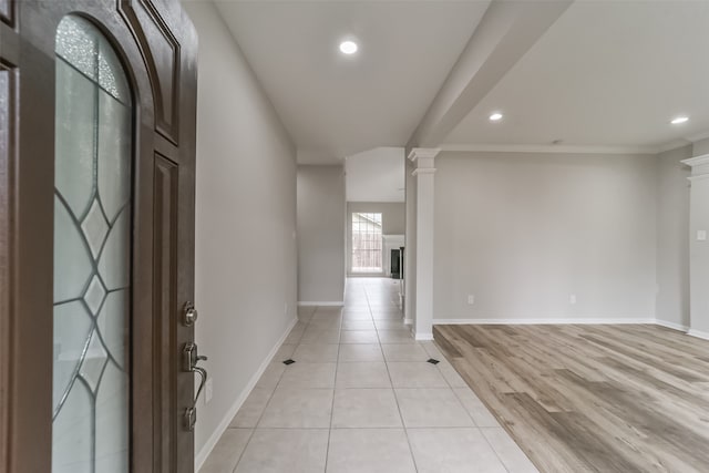 empty room with light wood-type flooring and decorative columns