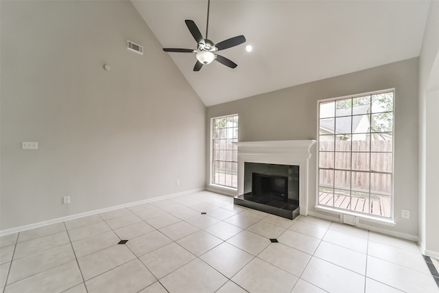 unfurnished living room featuring light tile patterned floors, ceiling fan, and a wealth of natural light