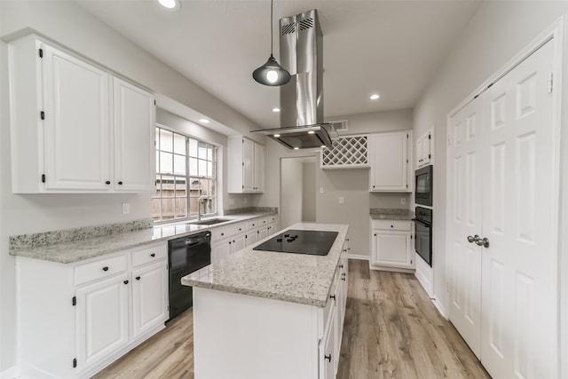 kitchen with black appliances, a kitchen island, white cabinets, and hanging light fixtures