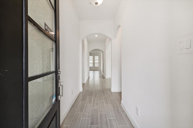 hallway with hardwood / wood-style flooring