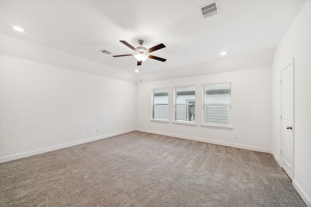 carpeted spare room with ceiling fan