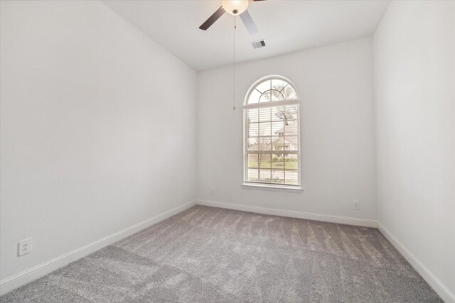 unfurnished room featuring lofted ceiling, carpet flooring, and ceiling fan