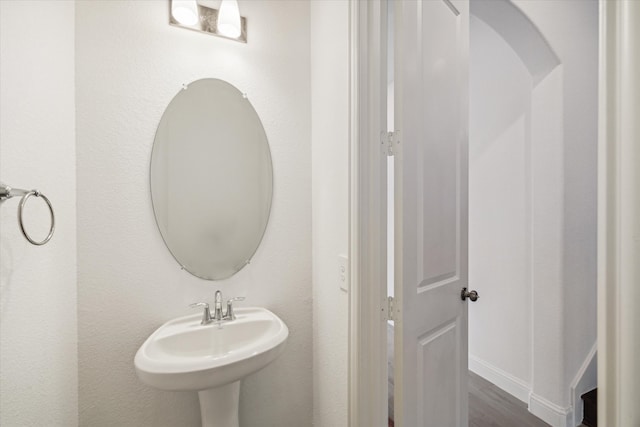 bathroom with hardwood / wood-style flooring and sink