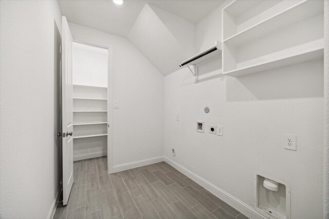 clothes washing area with washer hookup, hardwood / wood-style floors, gas dryer hookup, and electric dryer hookup