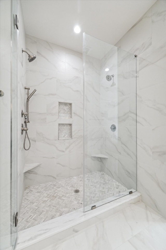 bathroom with a shower with door