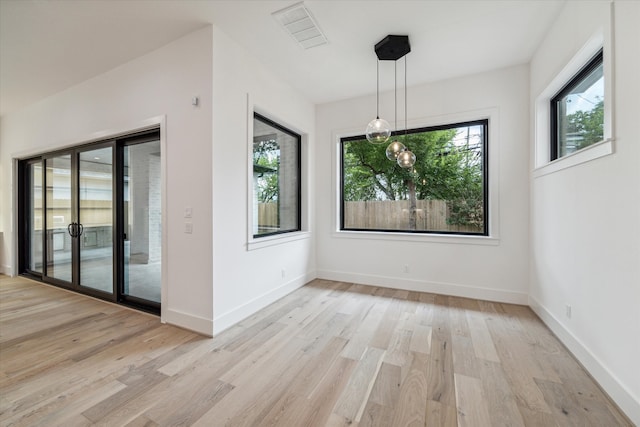 unfurnished dining area with light hardwood / wood-style floors