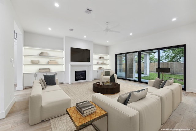 living room featuring light hardwood / wood-style flooring, ceiling fan, and french doors