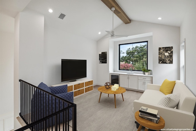 carpeted living room with ceiling fan, wine cooler, and lofted ceiling with beams