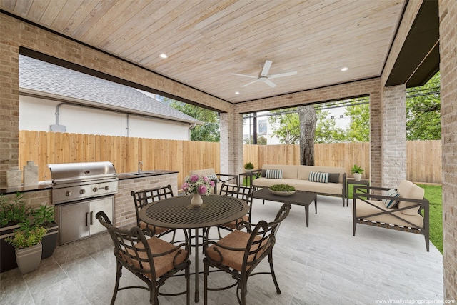 view of patio / terrace featuring ceiling fan, area for grilling, sink, an outdoor hangout area, and exterior kitchen