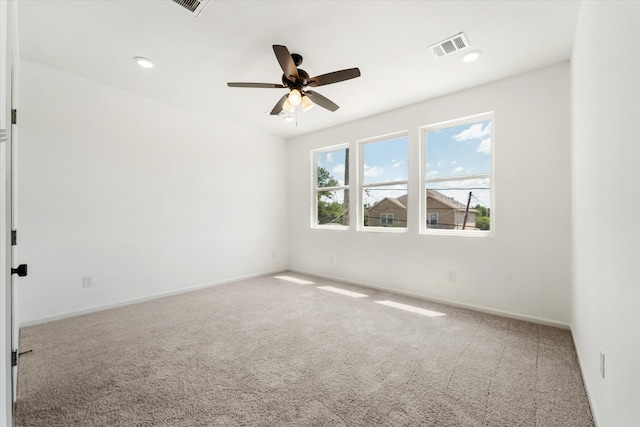 carpeted empty room featuring ceiling fan