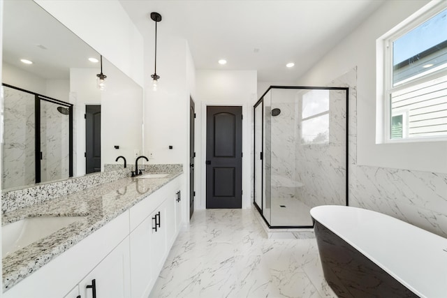 bathroom with vanity, a healthy amount of sunlight, and separate shower and tub