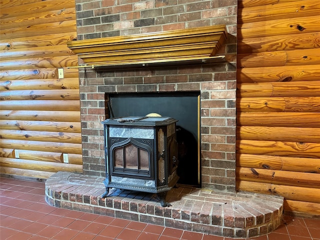 details featuring a wood stove and tile patterned flooring