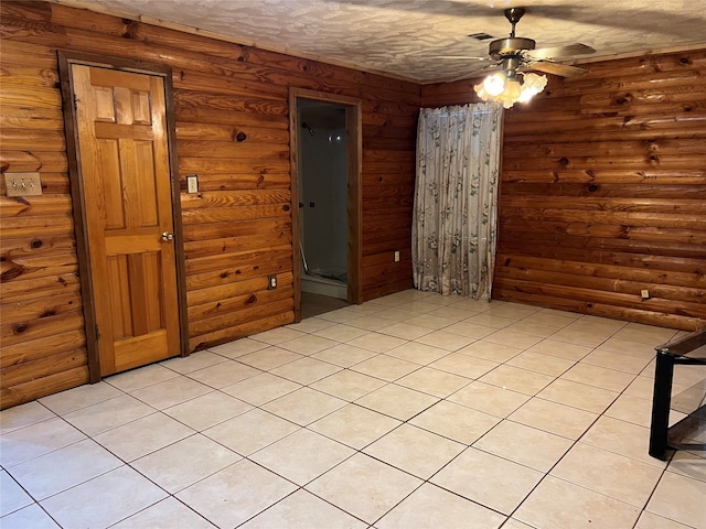 unfurnished bedroom featuring light tile patterned floors, log walls, and ceiling fan