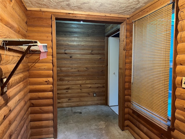 interior space with a textured ceiling and concrete flooring