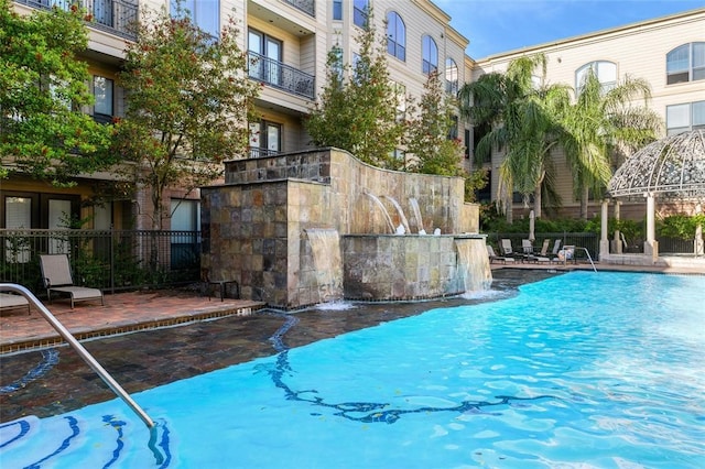 view of swimming pool featuring a gazebo and pool water feature