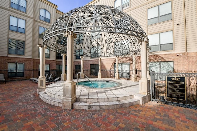 exterior space featuring a community hot tub and a patio