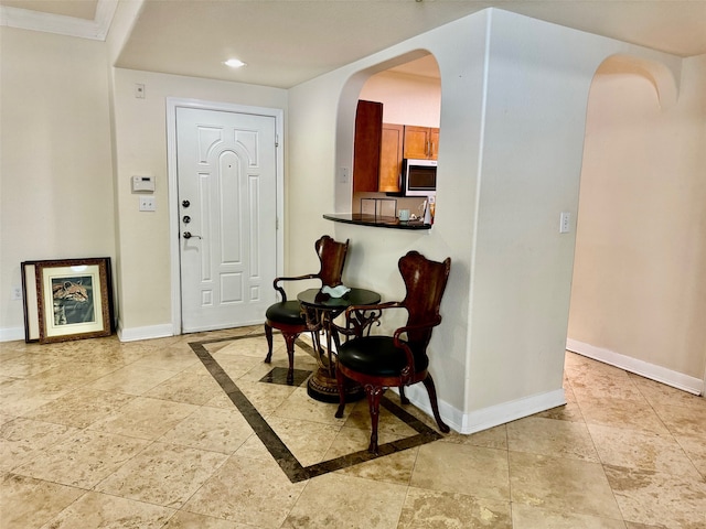 entryway featuring ornamental molding