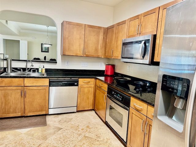 kitchen with sink, stainless steel appliances, decorative light fixtures, dark stone countertops, and crown molding