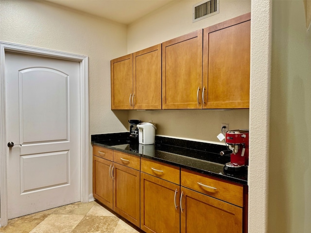 kitchen featuring dark stone countertops