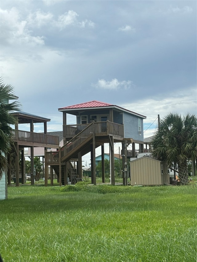 back of property with a yard, a shed, and a deck