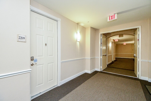 interior space featuring dark carpet