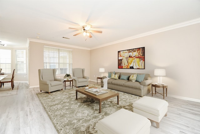 living room with crown molding, ceiling fan, and light hardwood / wood-style floors