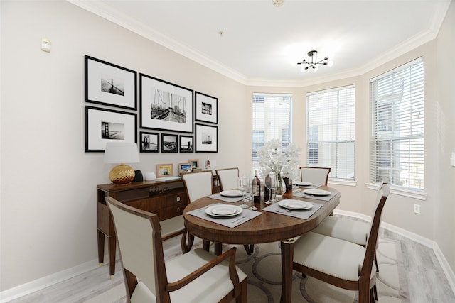 dining space with light wood-type flooring, ornamental molding, and a healthy amount of sunlight