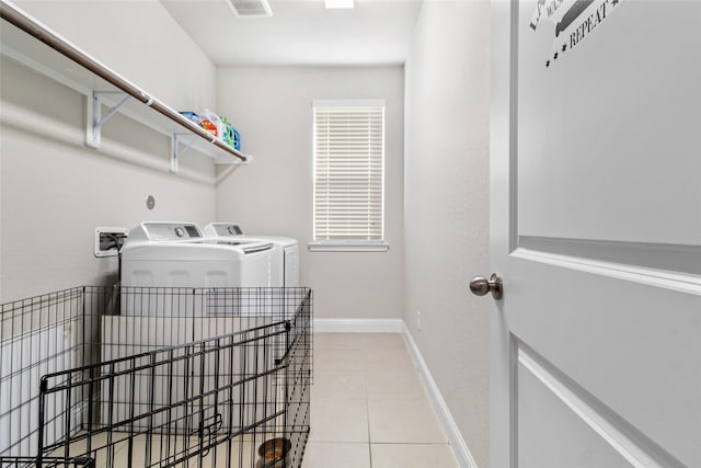 laundry room with separate washer and dryer and light tile patterned floors