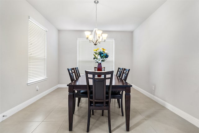 dining space with a notable chandelier and light tile patterned flooring