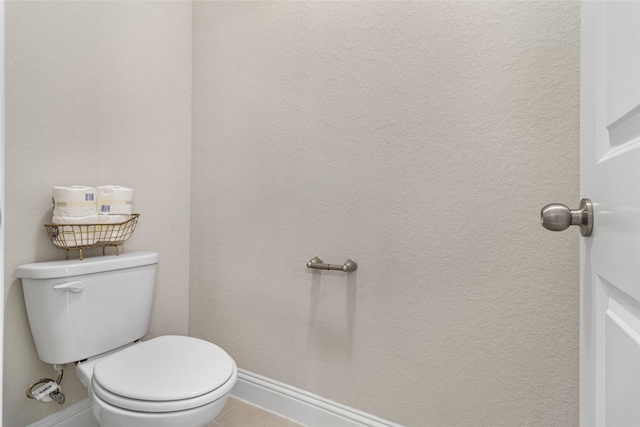 bathroom featuring toilet and tile patterned flooring