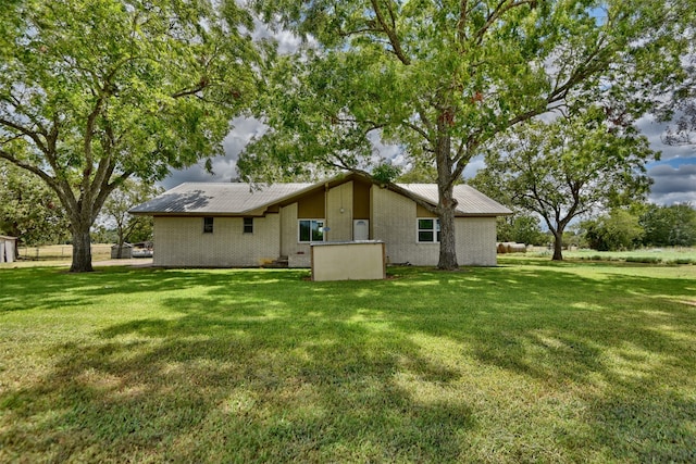 back of property featuring a lawn and a patio